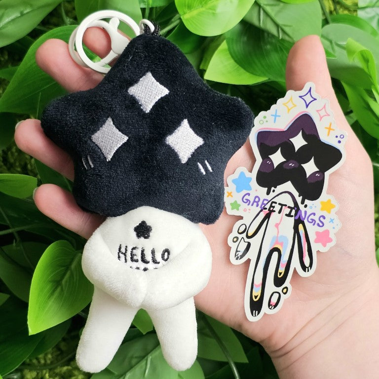 A black and white star baby plushie and the coordinating sticker.