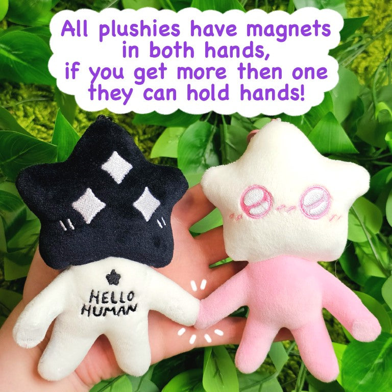 Two star baby plushies holding hands through the magnets in each of their hands.