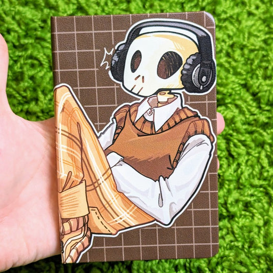 Front cover of a sketchbook with an aesthetic skeleton design