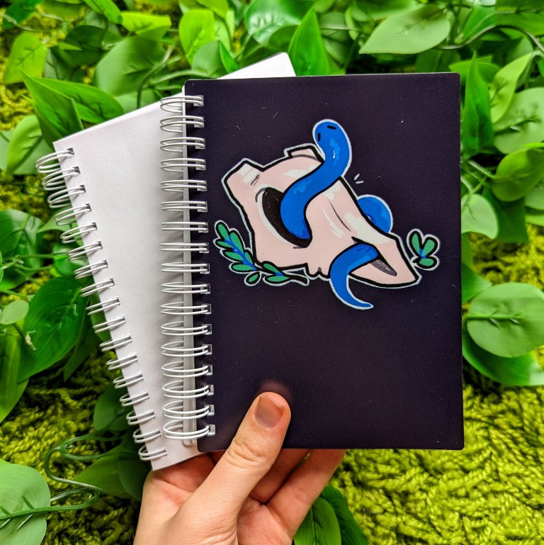 Front cover of skull and snake sticker book with an animal skull