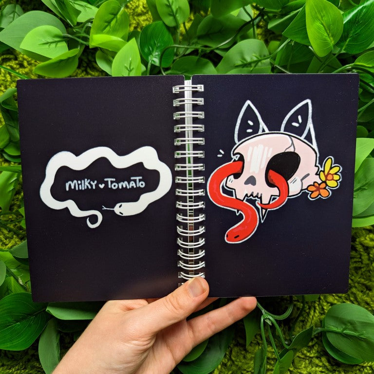 Front and back of red cat skull and snake sticker book