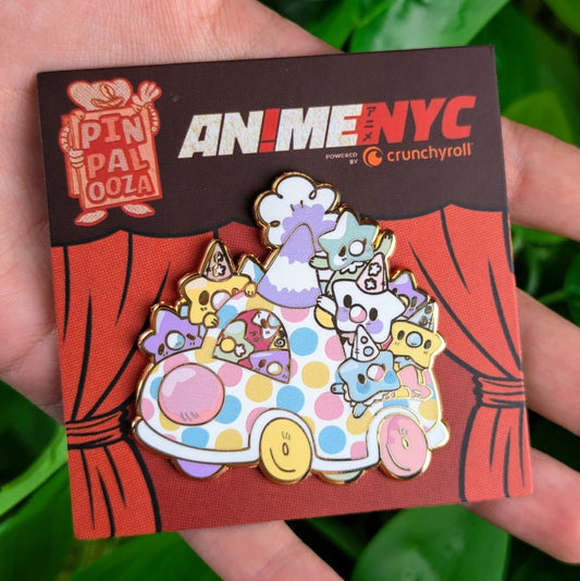 Star Baby Clown Car enamel pin on Pinpalooza Card from ANIMENYC in Milky's hand