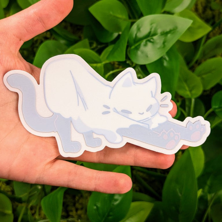 A Stretching Ghost Cat window sticker in Milky's hand