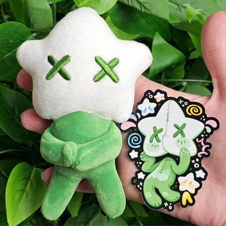 A green star baby plushie and the coordinating sticker.