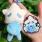 A blue star baby plushie and the coordinating sticker.