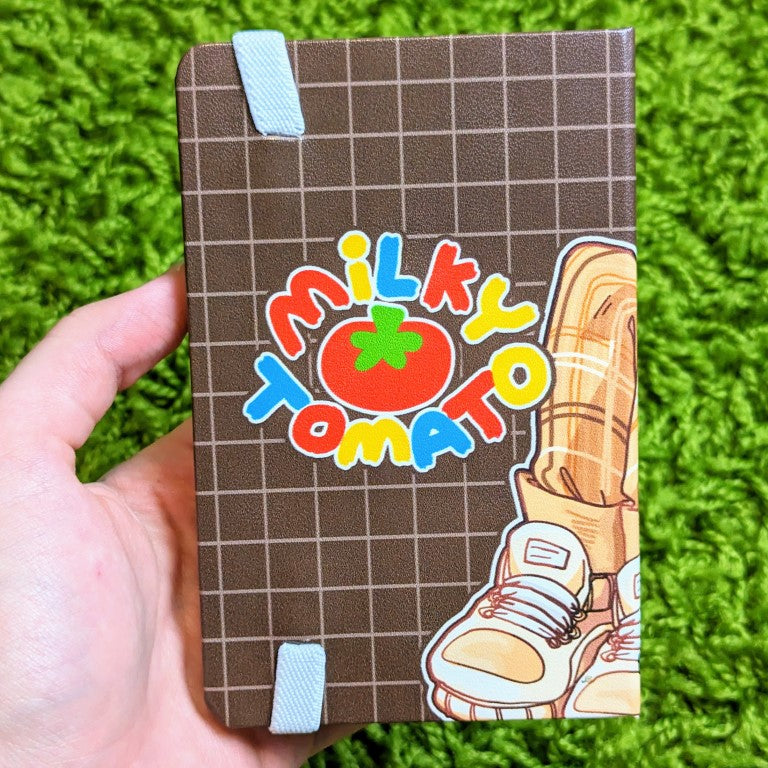 Back cover of a sketchbook with an aesthetic skeleton design and the milky tomato logo