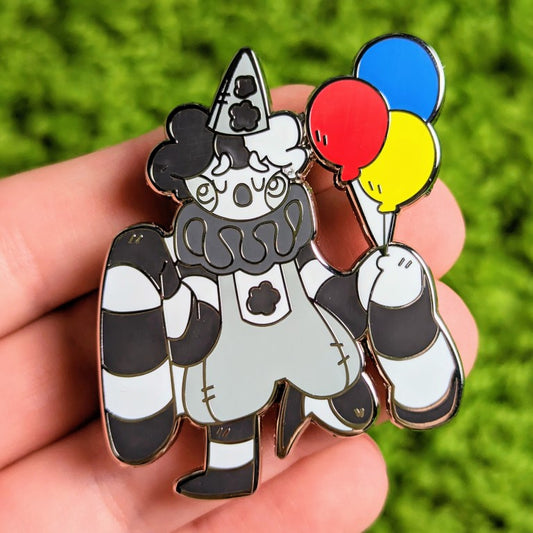 Adorable sad black, white, gray & silver old timey style clown with floppy sleeves, and red, blue, & yellow balloons.