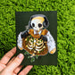 The mini brown Skeleton Cade chilling print.