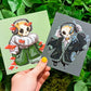 Two mini prints featuring an aesthetic skeleton design, one with red mushrooms and one with blue.