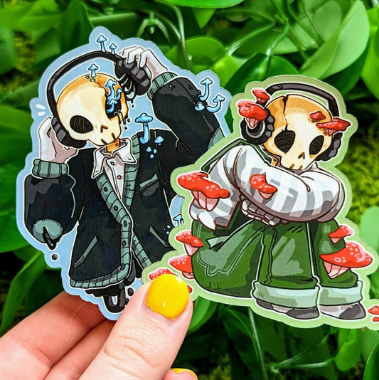Two stickers featuring an aesthetic skeleton design, one with red mushrooms and one with blue.