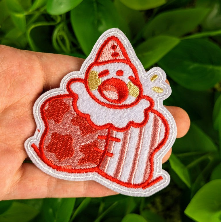 Red Clown patch in Milky's hand