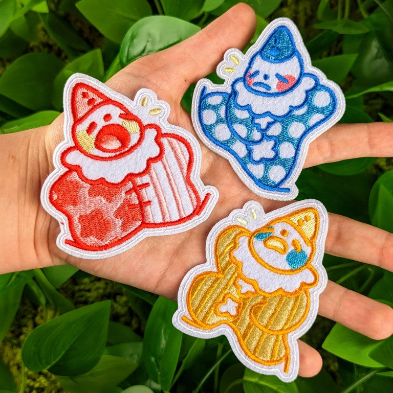 Three Lil Clown patches in Milky's hand