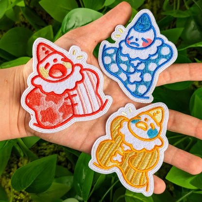 Three Lil Clown patches in Milky's hand