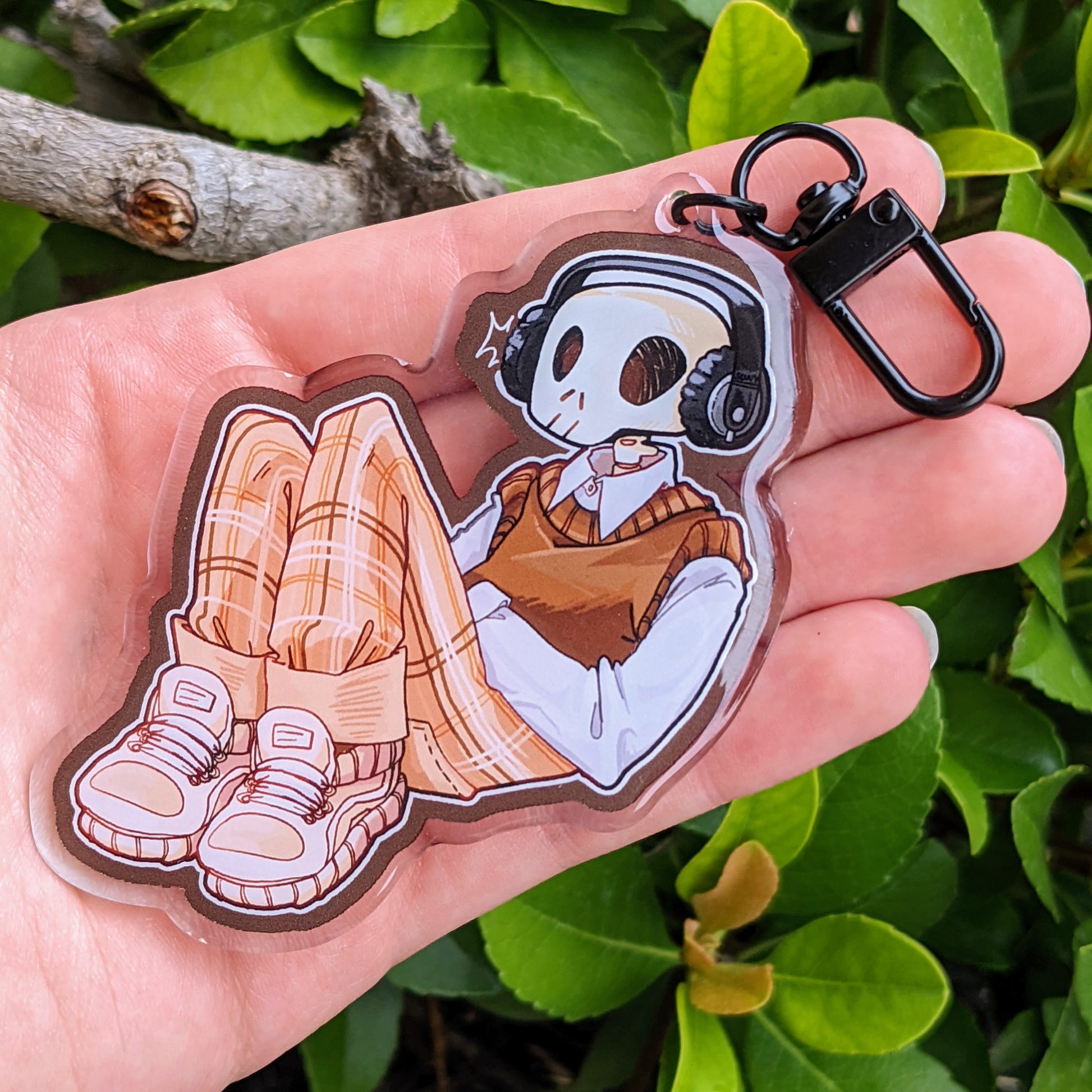 Aesthetic skeleton keychain showing Cade reclined and relaxed while listening to his favorite tunes.