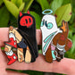 Close up view of both the angel and devil ghost enamel pins.